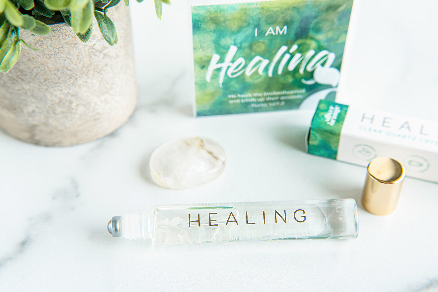 Roll-on bottle labeled 'Healing' with packaging on a marble surface.
