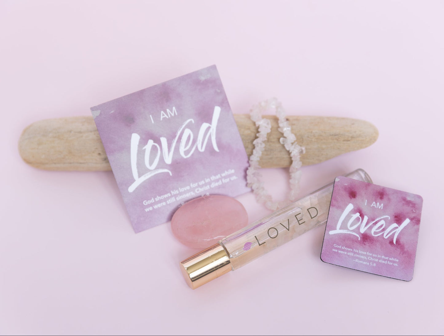 Products with 'I am Loved' packaging on a light pink background