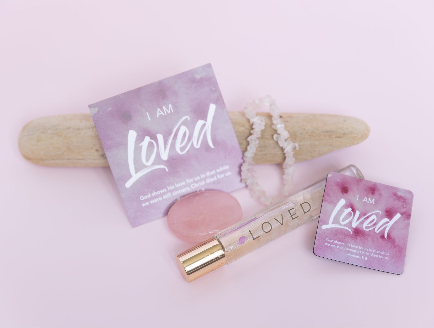 Products with 'I am Loved' packaging on a light pink background