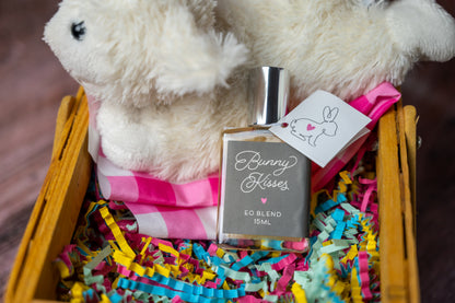 Bunny Kisses essential oil blend in a bottle in an Easter Basket with white bunny and colorful paper shreds