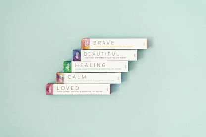 5 Boxes for Crystal Essential Oil Roller Blends on a pale aqua background in a step formation