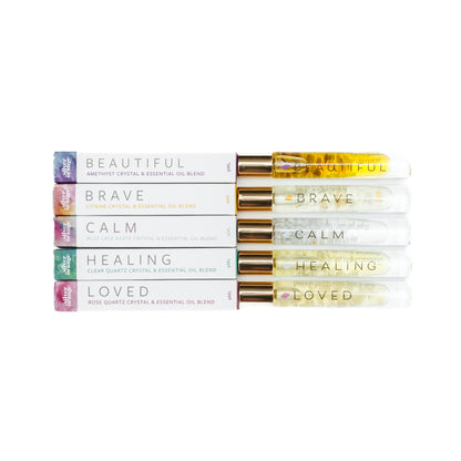 Stack of essential oil blends with labels on a white background