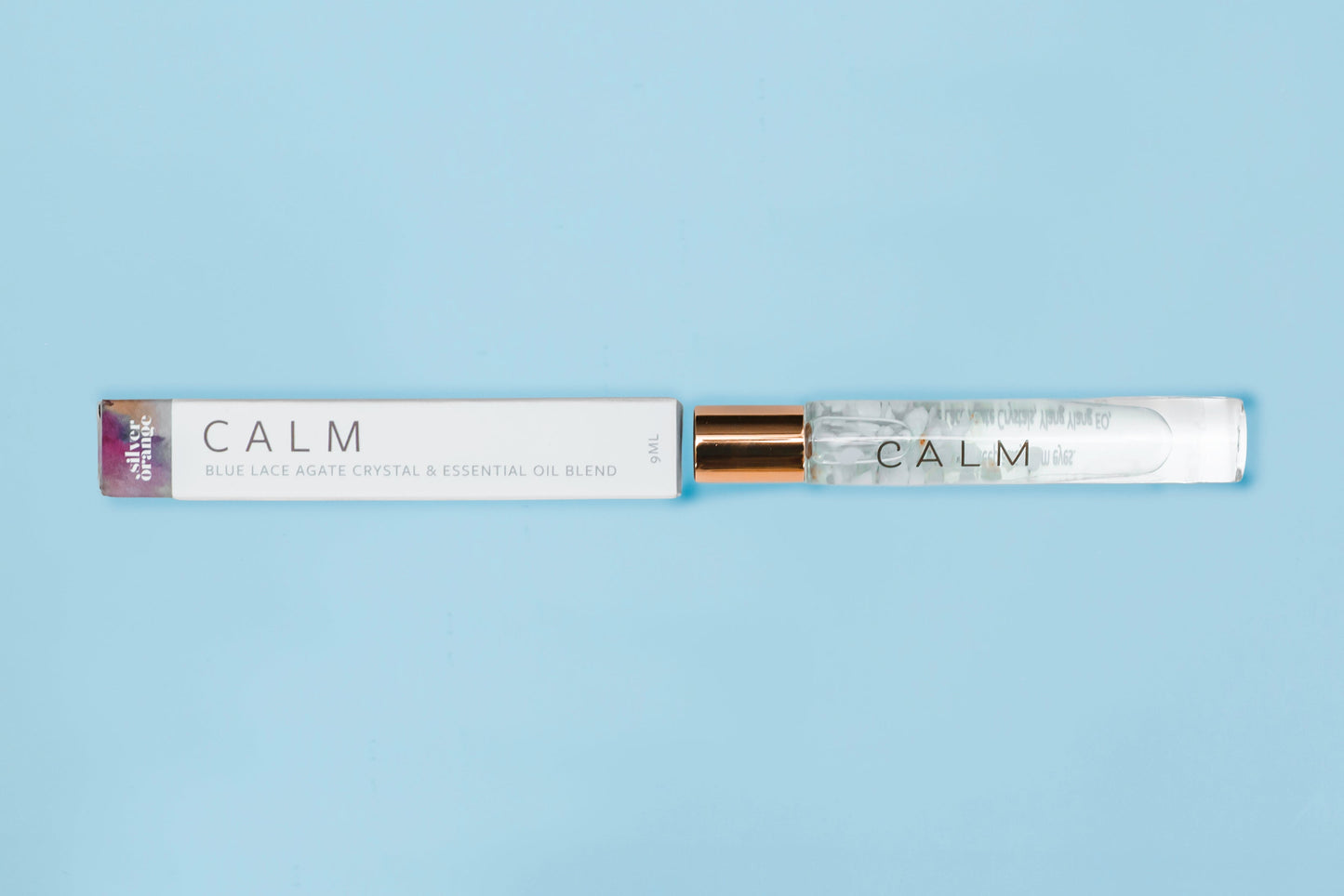 Roll-on bottle labeled 'CALM' on a light blue background
