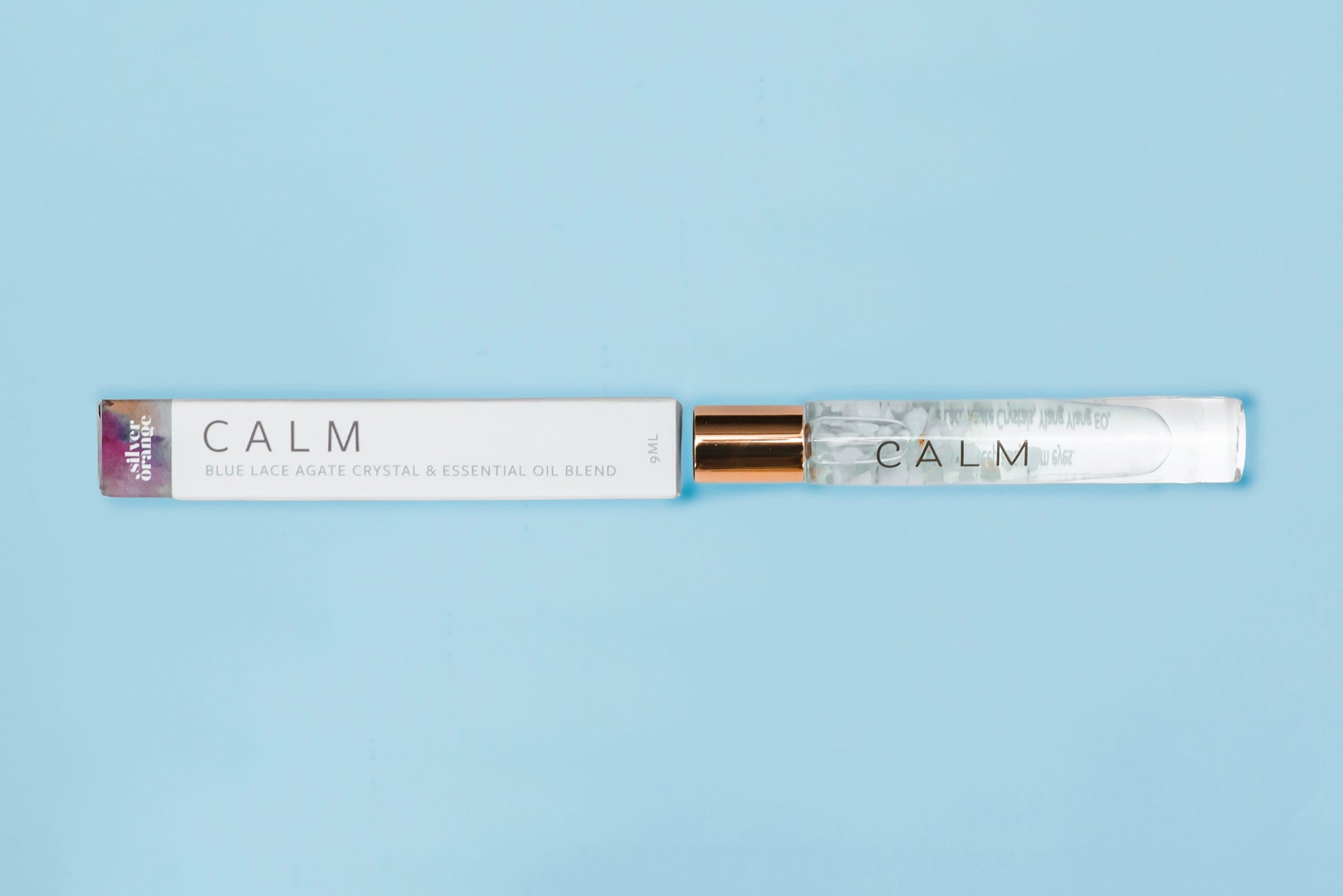 Roll-on bottle labeled 'CALM' on a light blue background