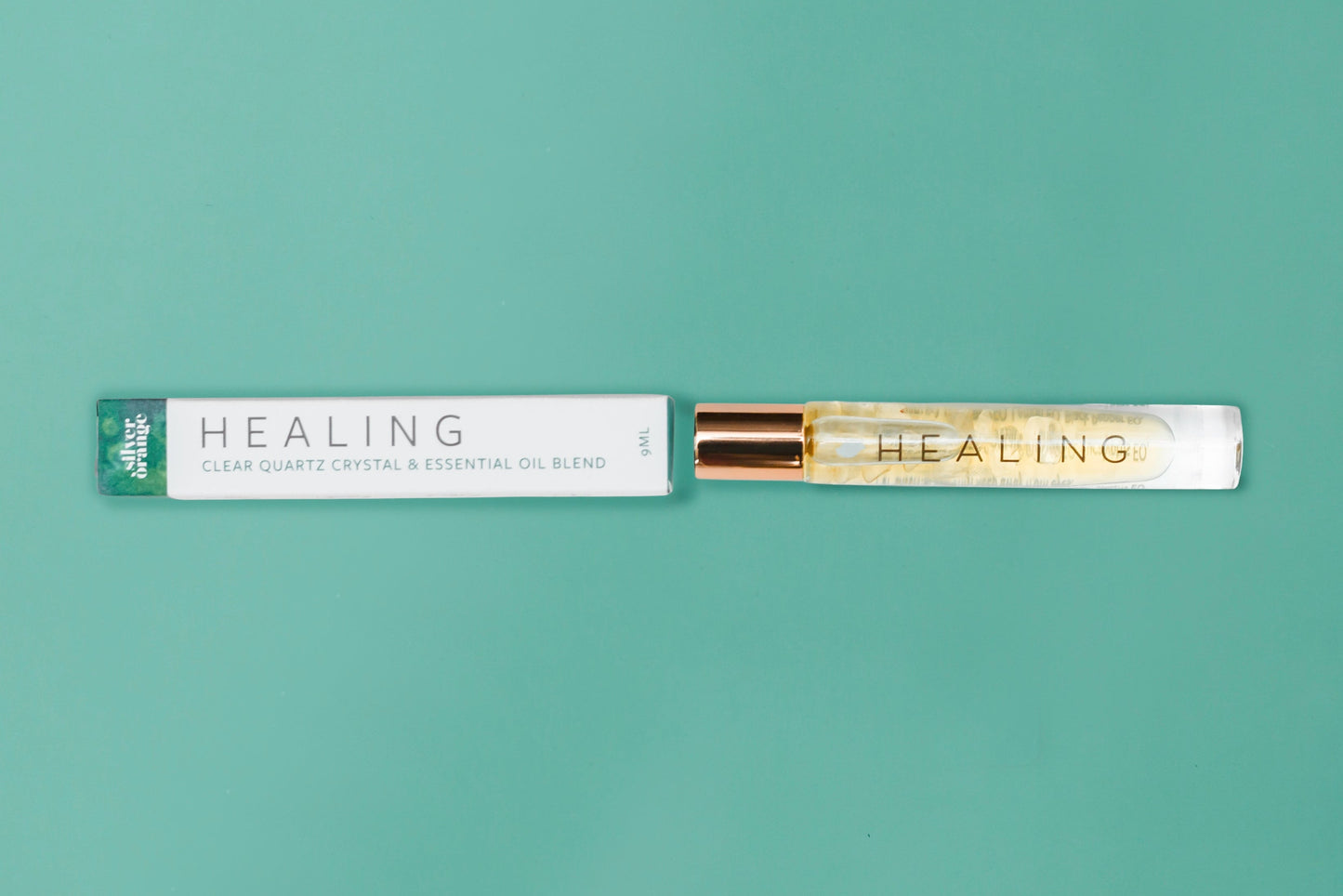 Roll-on bottle labeled 'HEALING' with a matching packaging on a teal background
