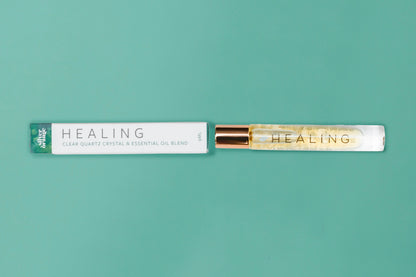 Roll-on bottle labeled 'HEALING' with a matching packaging on a teal background