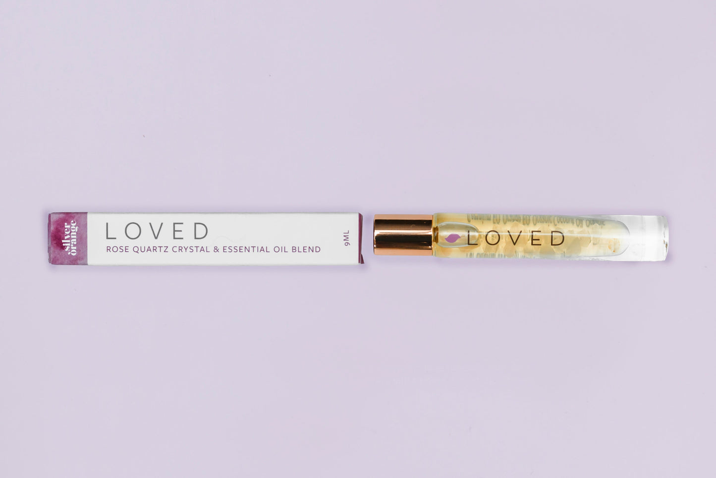 Roll-on bottle labeled 'LOVED' with a purple cap on a light gray background
